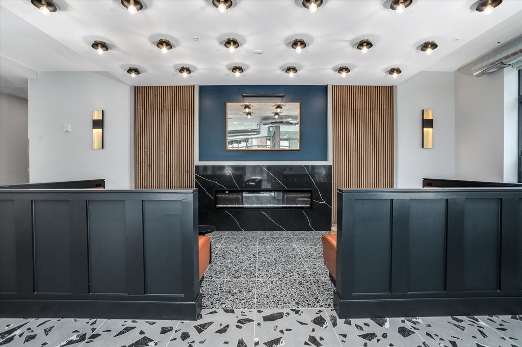 a view of a lobby with black and white tiles and a blue wall with a a view of a lobby with black and white tiles and a blue wall with a at Beekman on Broadway, Michigan, 48105